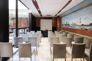 a room with white chairs and a projection screen at Catalonia Port in Barcelona