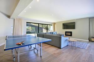 a living room with a ping pong table and a couch at Villa Frangipani in Cape Town