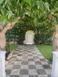 a garden with a checkered floor and a tree at Villa dei Gelsi in Leporano Marina