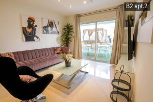 a living room with a couch and a table at YalaRent Palmore Resort apartments in Eilat