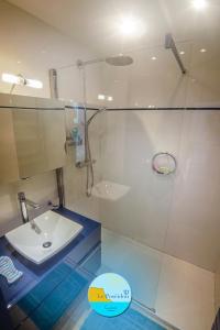 a bathroom with a glass shower with a sink at LE POSEIDON VUE MER in Cassis
