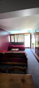 a room with two beds and a table in it at Departamento Penitentes Lomas Blancas in Los Penitentes