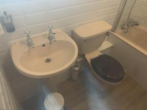 a bathroom with a sink and a toilet at The Manners Pub with Rooms in Bakewell