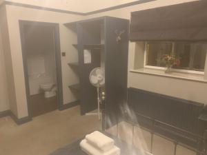 a bathroom with a toilet and a window at The Manners Pub with Rooms in Bakewell