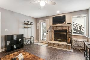 a living room with a fireplace and a flat screen tv at LightHouse Cove #208 in Wisconsin Dells