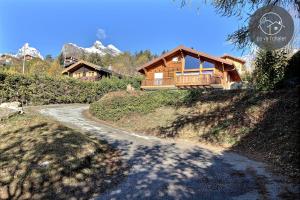 a house on top of a hill with a road at L'Eden in Ovronnaz