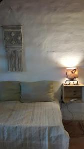 a bedroom with a bed and a table with a lamp at COMPLEJO DRUMMOND en el Camino del Vino in Ciudad Lujan de Cuyo