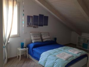 Postel nebo postele na pokoji v ubytování Spegni La Luce b&b