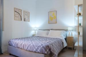 a bedroom with a bed with a purple comforter at Casa del Laureato by Studio Vita in Bologna