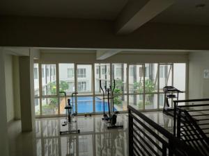 a room with windows and a pool in a building at PADINA SUITES in Poris