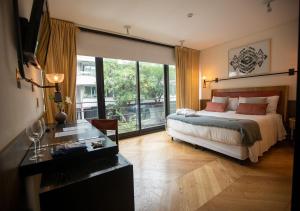 - une chambre avec un lit et une grande fenêtre dans l'établissement Hotel Palermitano by DOT Boutique, à Buenos Aires