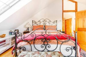 a bedroom with a bed with a red blanket at Urban Oasis in Hope Village in Providence