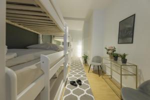 a bedroom with two bunk beds and a rug at The Harbour Apartment 1 in Hamburg