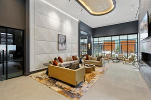 a lobby with couches and tables and windows at WhyHotel by Placemakr, Columbia in Columbia