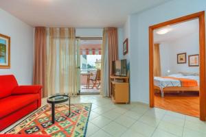 a living room with a red couch and a bedroom at Cencherle in Novigrad Istria