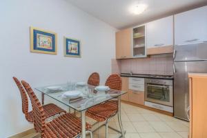 a kitchen with a table and chairs and a refrigerator at Cencherle in Novigrad Istria