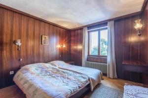 a bedroom with wooden walls and a bed with a window at Apartment Alenka in Novigrad Istria