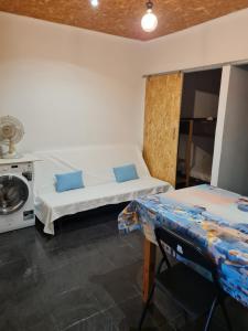 a room with two beds and a table in it at Casas de praia Sandra e Nelson in Almada