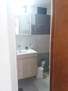 a bathroom with a sink and a toilet at Studio George - near the beach in Matala