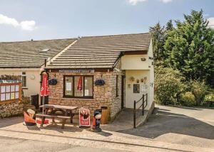 a small building with a picnic table in front of it at Hillcroft Park in Pooley Bridge