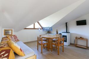 ein Wohnzimmer mit einem Tisch und einem Sofa in der Unterkunft Residence Equilio in Lido di Jesolo