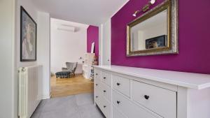a white dresser in a room with a purple wall at Apartment Iriska in Novigrad Istria +16 photos