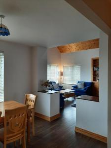 a living room with a table and a blue couch at Skye's Atlantic Retreat in Miltown Malbay