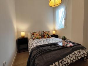 a bedroom with a bed with a tray on it at Precioso apartamento en Puente Vallecas, Madrid. D in Madrid