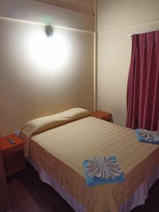 Un dormitorio con una cama con una caja azul. en Alojamiento céntrico florida en Puerto Iguazú