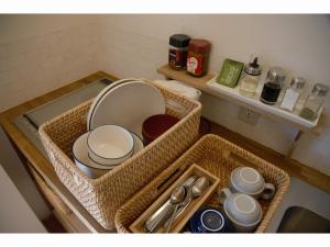 a sink with dishes and utensils in a kitchen at Mountain Home Lodge in Deer Park in Nara