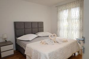 a bedroom with a large bed with a large window at Dalmata D in Podstrana