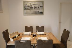 a dining room with a wooden table and chairs at Dalmata D in Podstrana