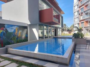 een huis met een zwembad voor een gebouw bij Aqua View Apartments in Bijilo