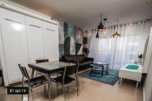 a living room with a table and a couch at YalaRent Palmore Resort apartments in Eilat
