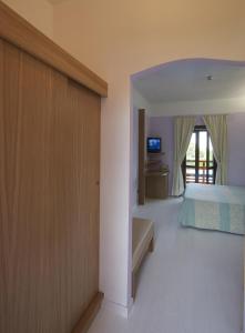 
a room with a bed and a door at Hotel Cala Reale in Stintino
