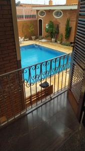 a view of a swimming pool from a balcony at Pousada Hospede Olimpia in Olímpia