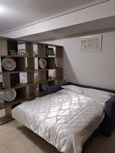 a bedroom with a large bed and wooden shelves at C & D Karlovasi apartment in Karlovasi