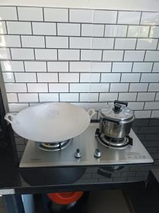 a pan on top of a stove with a pot at Aila Homestay Pendang in Pendang +18 photos