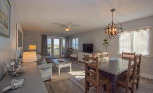 a dining room and living room with a table and chairs at 187 Beach Club Villa in St. Helena Island