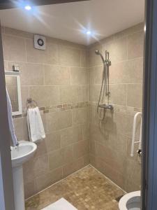 a bathroom with a shower and a sink at Palmer's Ale House in Long Sutton