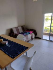 a room with a table and chairs and a couch at Residencia Merlo in Rafaela