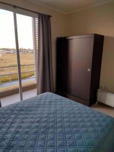 a bedroom with a bed and a large window at Residencia Merlo in Rafaela