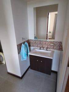 a bathroom with a sink and a mirror at Residencia Merlo in Rafaela