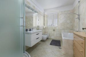 a bathroom with a sink and a toilet and a shower at Penthouse Lorena in Poreč