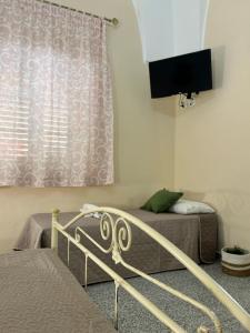 TV a/nebo společenská místnost v ubytování Meta Salento Rooms