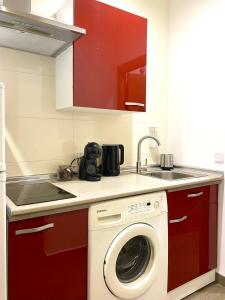 a kitchen with a washing machine and a sink at Apartamentos Fuencarral in Madrid