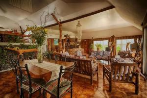 a large living room with a table and chairs at CHEZ MARIA GORETTI HOTEL in Hanga Roa