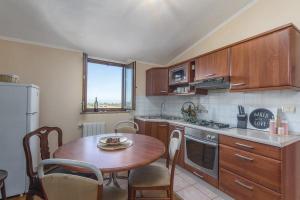 a kitchen with a wooden table and a table and chairs at Appartment Arrburoni in Novigrad Istria
