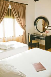 Postel nebo postele na pokoji v ubytování Hotel Sibayak Internasional