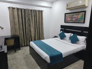 a hotel room with a bed and a window at CABANA REGENCY in Gurgaon